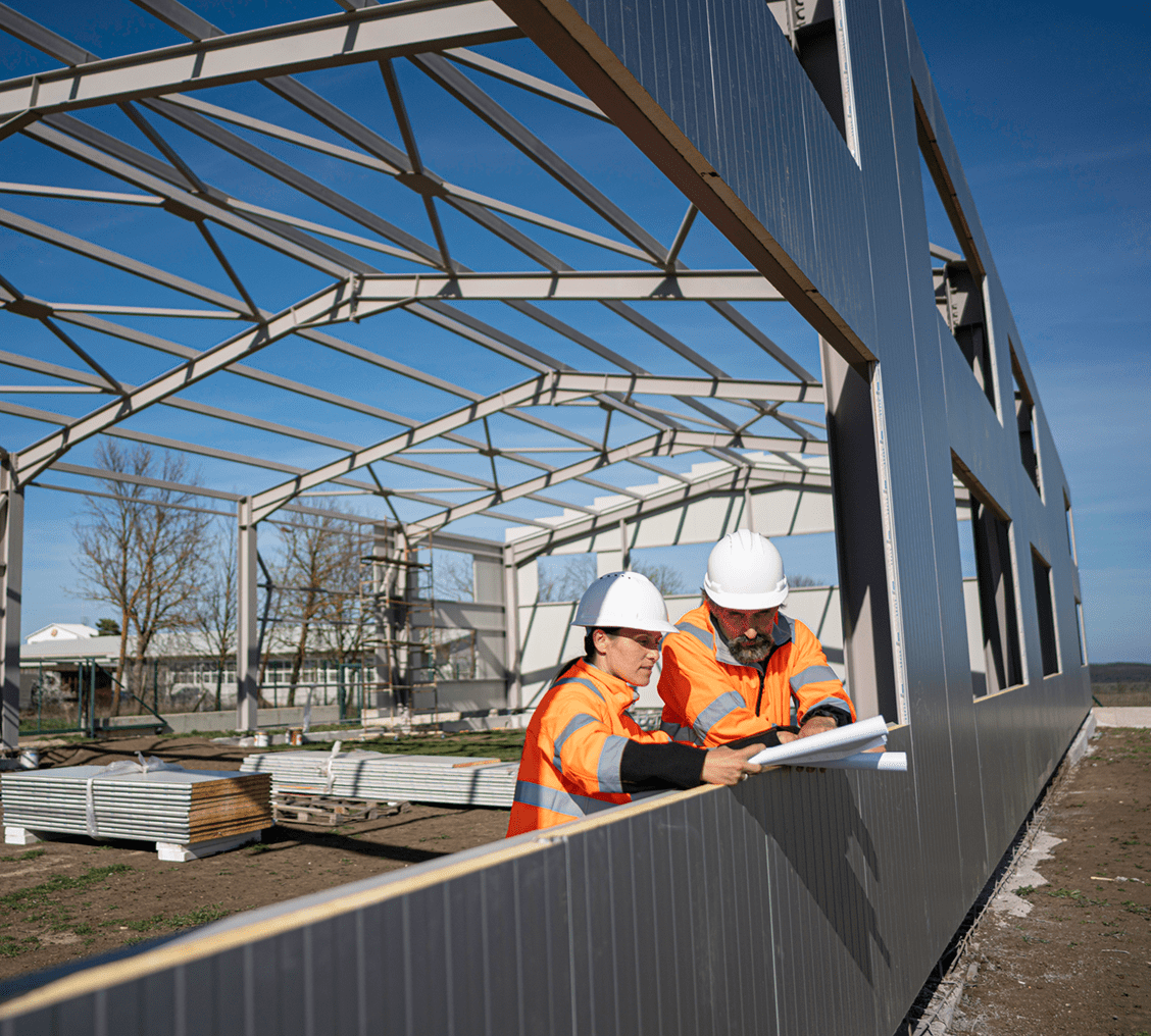 Construction workers reviewing building plans